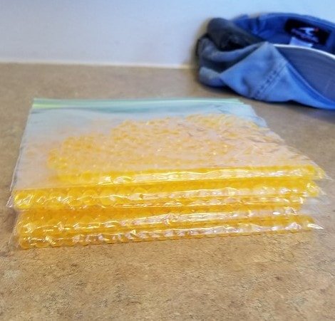 A stack of loose spawn in bags that are ready to be stored in the freezer.