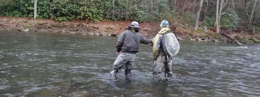 A guide with all the right fly fishing gear and his client