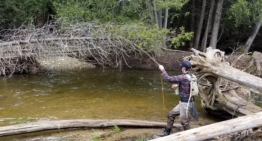 This trout angler is my client, and he has his net hanging off the back of his vest with the hoop part down. This makes grabbing the net tough and makes it more likely to get the net mesh caught on something and tear.