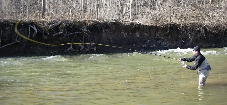 An angler making a long cast. dry fly fishing leader