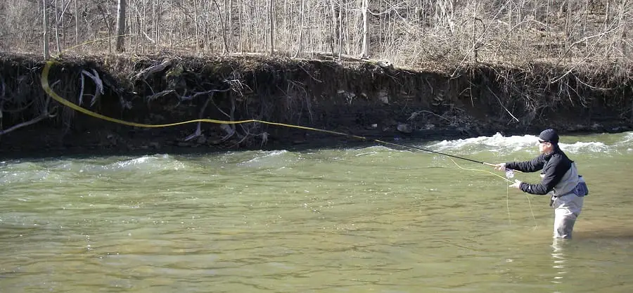 An angler using the right pound test leader for steelhead on a dirty river rivers