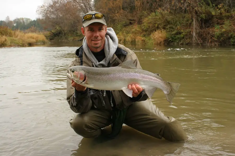 This trout was caught in the clear water from the creek that enters behind me in the picture