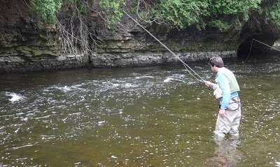 An angler Euro Nymphing some faster water