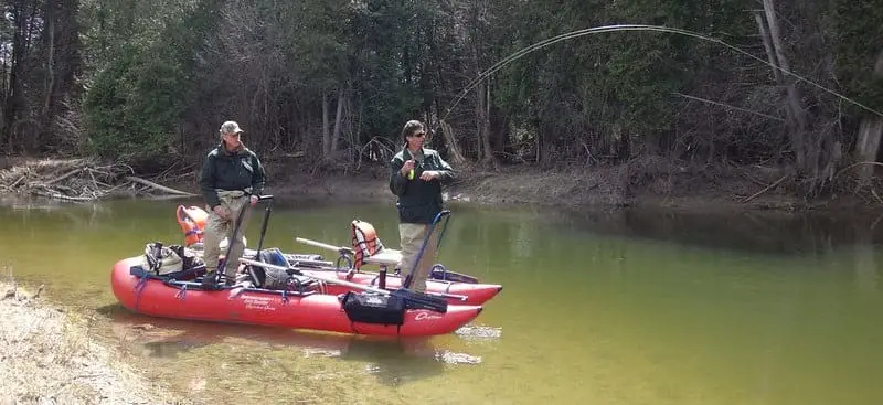 Stand up pontoon boats make great fly fishing boats - Two angler standing on a in the river