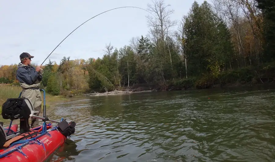 An angler fighting a big fish - knowing how deep to set your float is a critical part of good float fishing