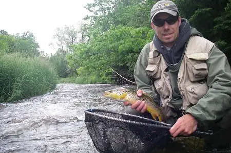 A guide wearing a best fly fishing vests from 20 years ago