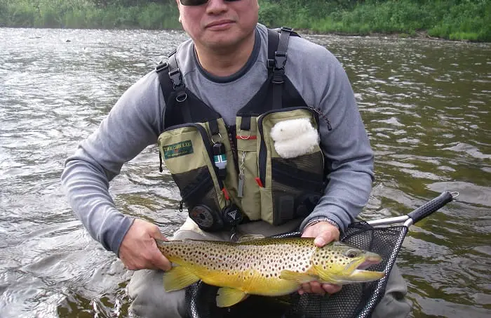 An angler wearing aone of the best fishing vests for comfort