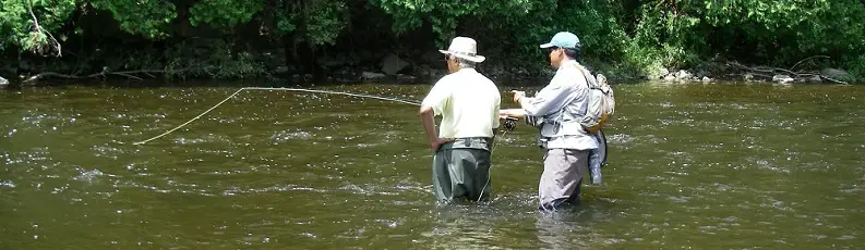 A top river fishing guide with a fly fishing client