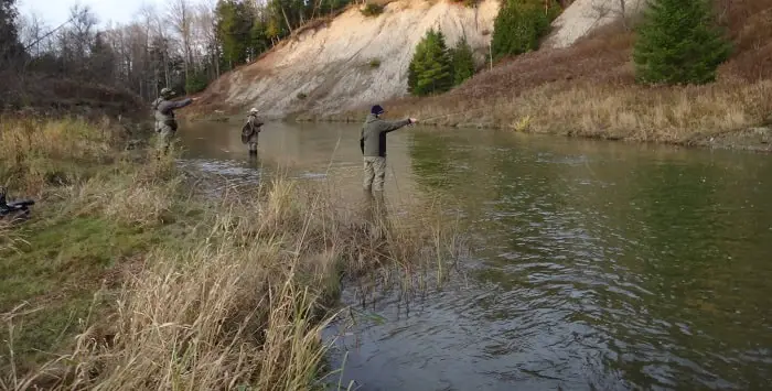 Anglers fishing a river in the fall steelhead season