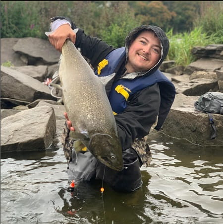 Dylan with a salmon caught on a float fishing bead rig.