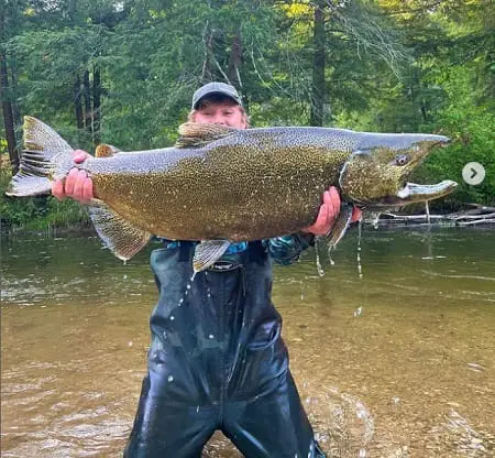 Eli from SBS Outdoor Action with a big Chinook salmon.