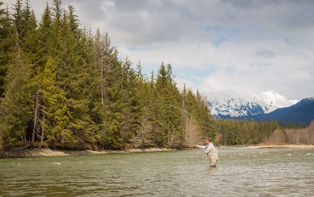 A fly fisherman casting on the Kalum River in the Skeena Region of British Columbia, Canada
