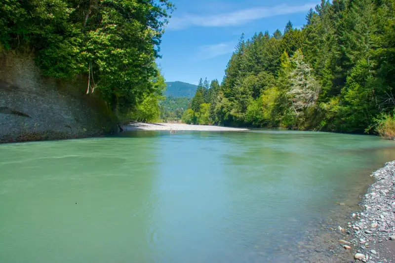 The Van Duzen River in Humboldt County, California runs "steelheaad green" on a sunny spring day.