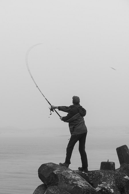 An angler shore fishing for great lakes brown trout