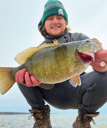 Eli from SBS Outdoor action with a fat smallmouth bass.