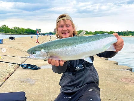 Eli from SBS Outdoor Action with a nice steelhead caught on a Lake Michigan Pier.