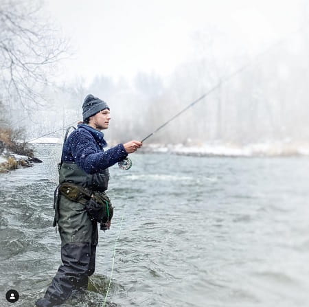 An angler fishing in the winter.