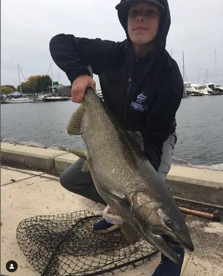 Our photographer Matt from @ wisco_castin with a salmon caught in a Marina.