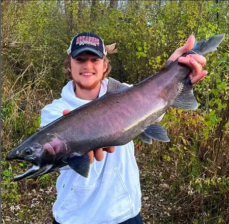 An angler with a nice coho salmon.