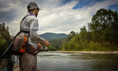 An angler with an ultralight spinning rod and reel for trout.