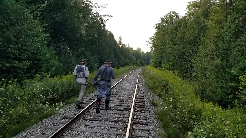 One of my clients and my guides hiking into a fishing spot with travel fly rods