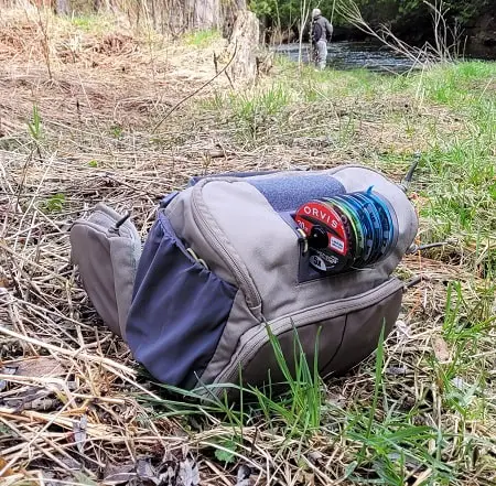 My Orvis fly fishing pack on the bank of the river.