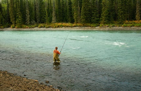 An angler fishing a large salmon river.