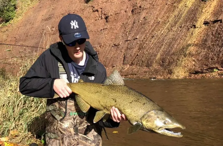 Our team photographer Noah with a great lakes salmon. See more from Noah on Instagram