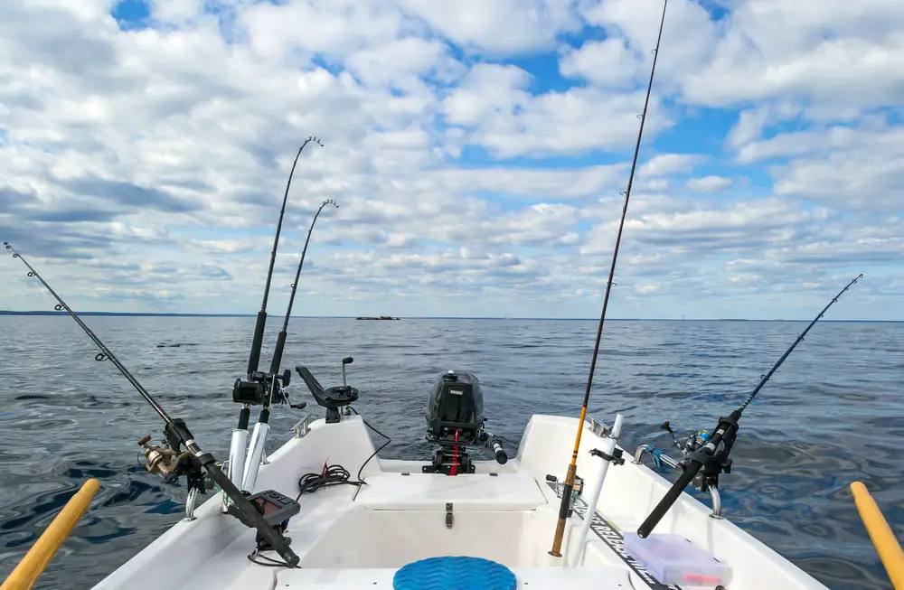 Trolling rods out the back of a boat with a good spread for the best trolling lures for great lakes salmon.