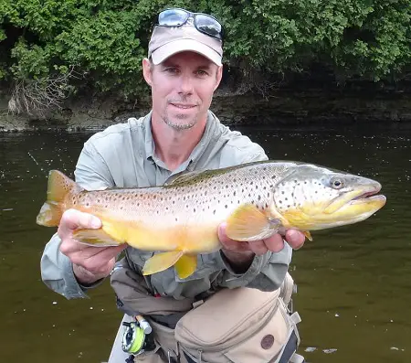 Most anglers wear hats and glasses, myself included. This is me holding a big brown trout.