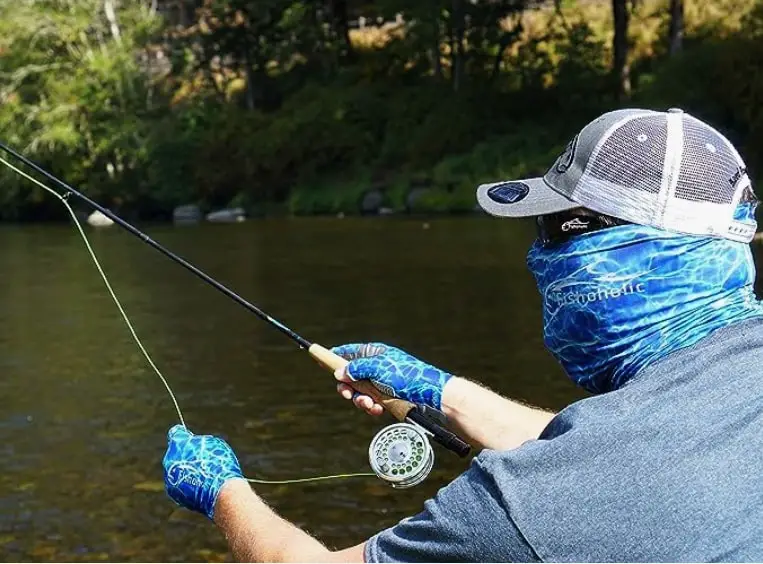 An angler wearing the Fishalolic Gaiter which makes our list of the Best Neck Gaiters For Fishing
