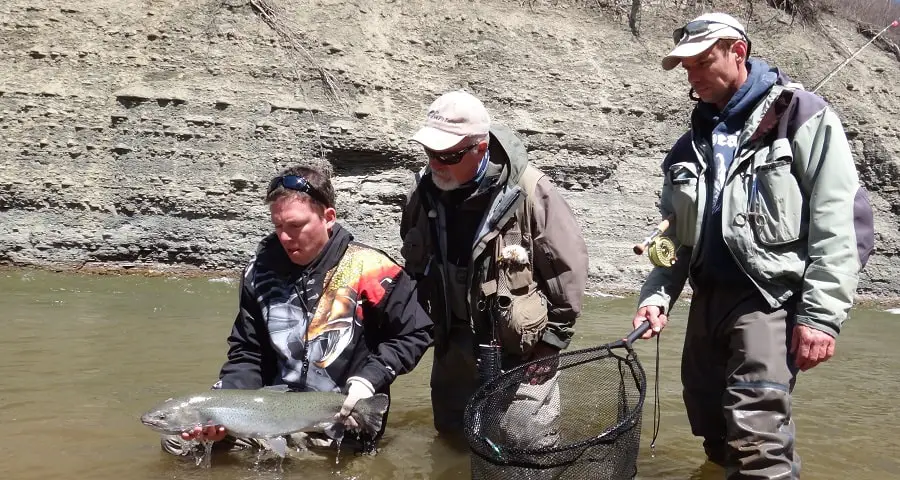 Me standing beside two anglers with a Frabill Wading net.