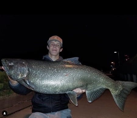 Matthew with a huge salmon caught at night