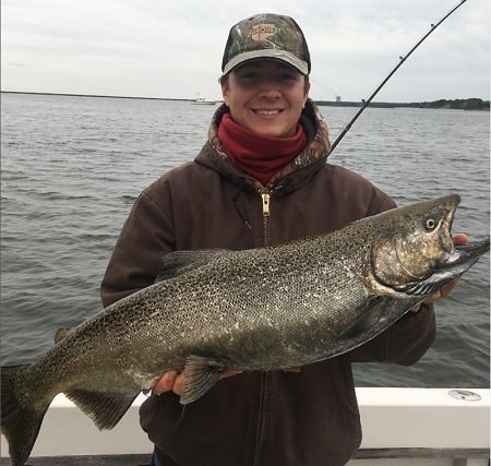 Michael Healy Outdoors with a new your salmon caught from a boat