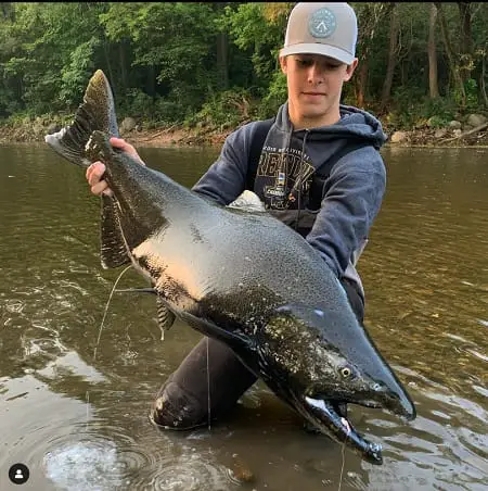 Salmon fishing in Wisconsin rivers can produce huge salmon like this one held by out photographer Matthew.
