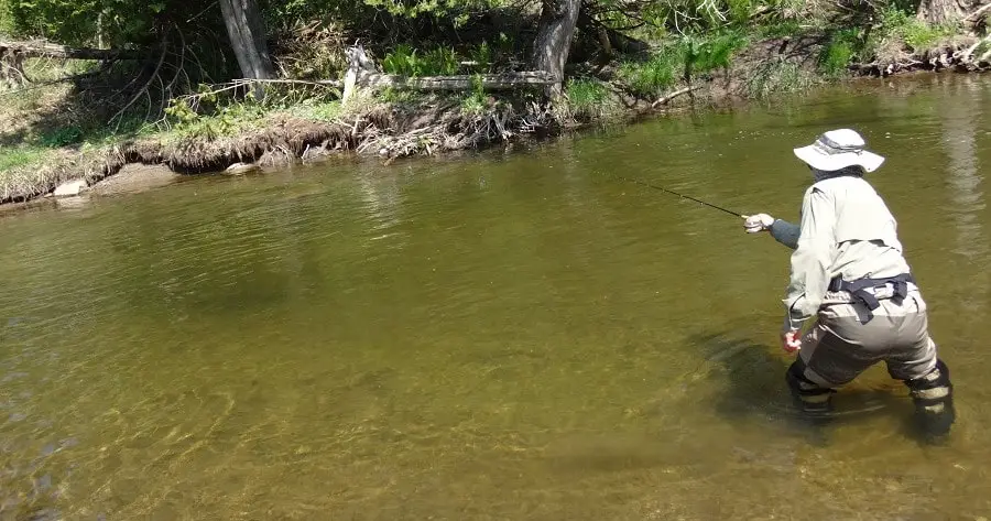 One of my clients fishing and wearing a good fishing hat for river fishing.