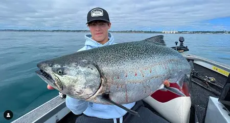 An angler with a large Lake Michigan King salmon.