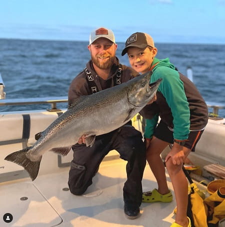 Alex and his young client with a large king salmon.