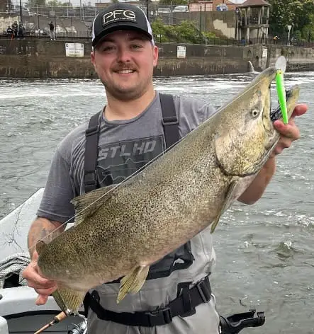 Dylan with a big salmon caught using spinning gear.