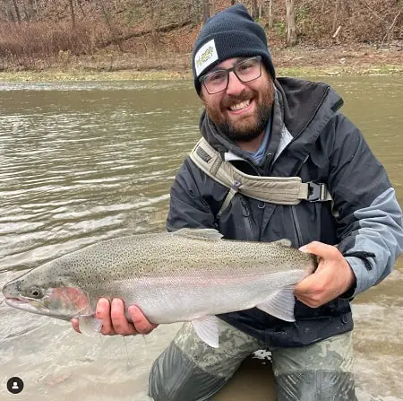 Andrew from Full Full Fishing Guide Service holding a nice steelhead on Cattaraugus Creek