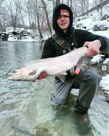 Dalton holding a big steelhead while winter steelhead fishing in Pennsylvania