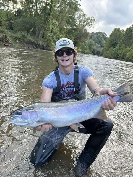 A Pennsylvania angler with a giant steelhead from one of the best steelhead rivers in PA