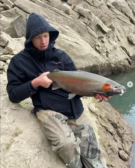 Noah on the rocks with a a Niagara River Steelhead.