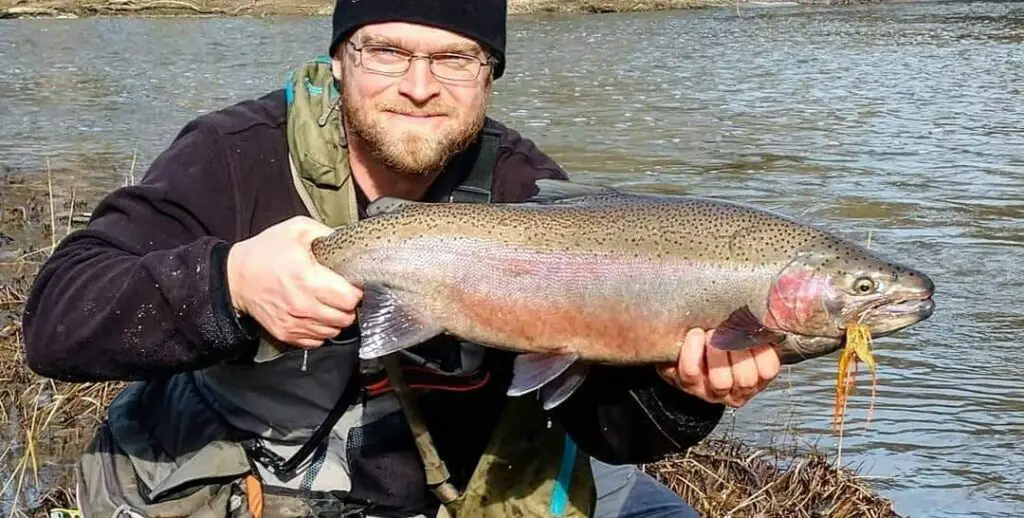 Gareth with a big steelhead with a fly in it's mouth.