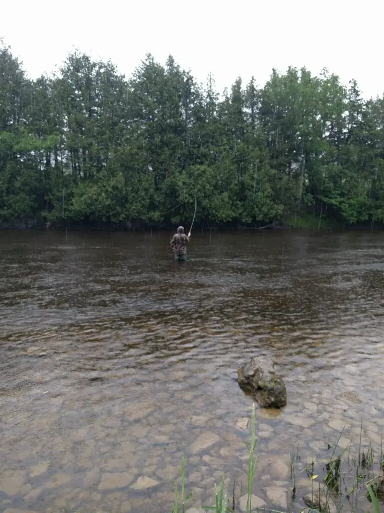 The authors client fishing in the rain.